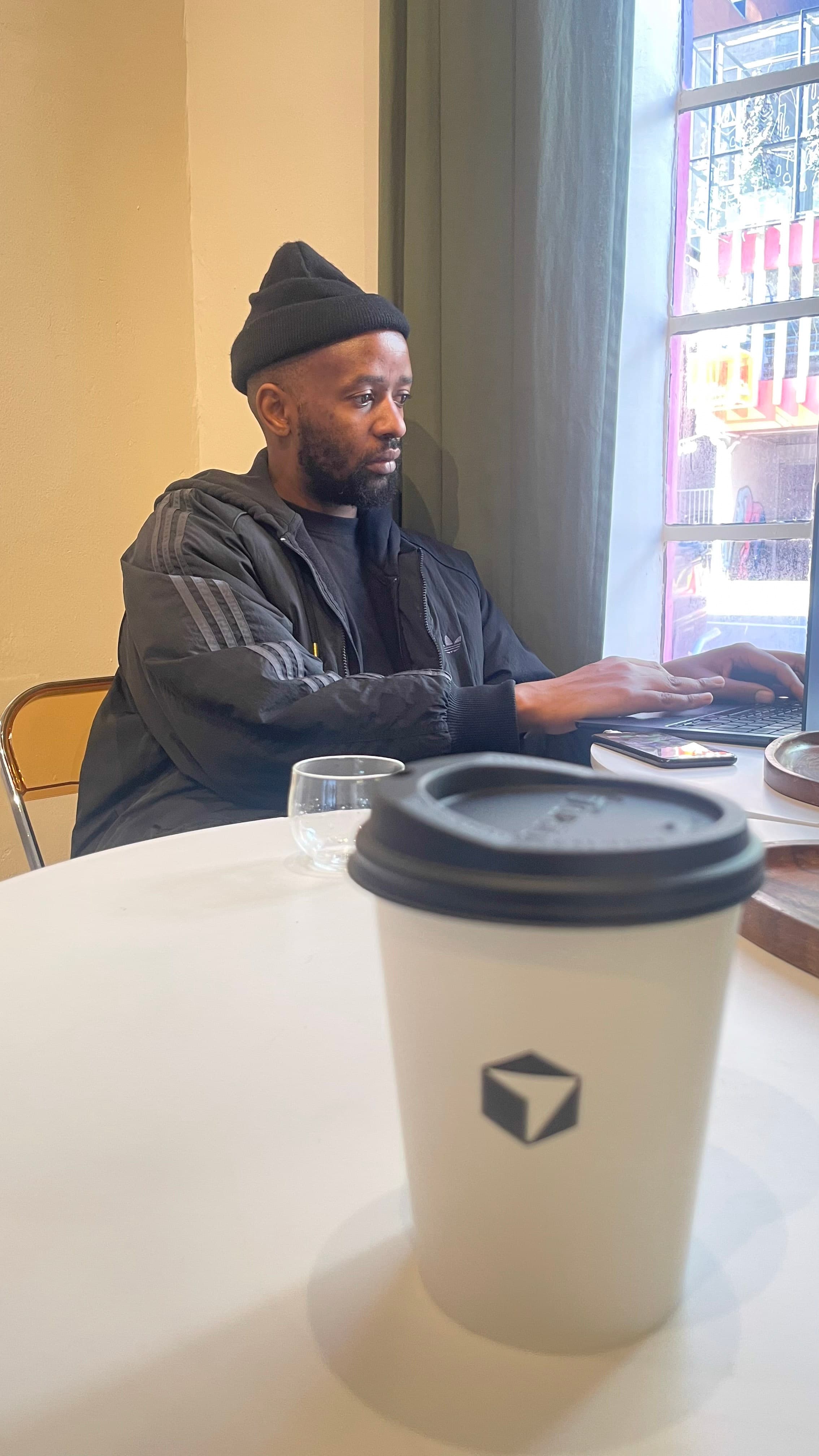A builder focused on their laptop during the Cafe Cursor Johannesburg session